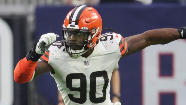 Browns defensive end Jadeveon Clowney runs to tackle a player during a game.